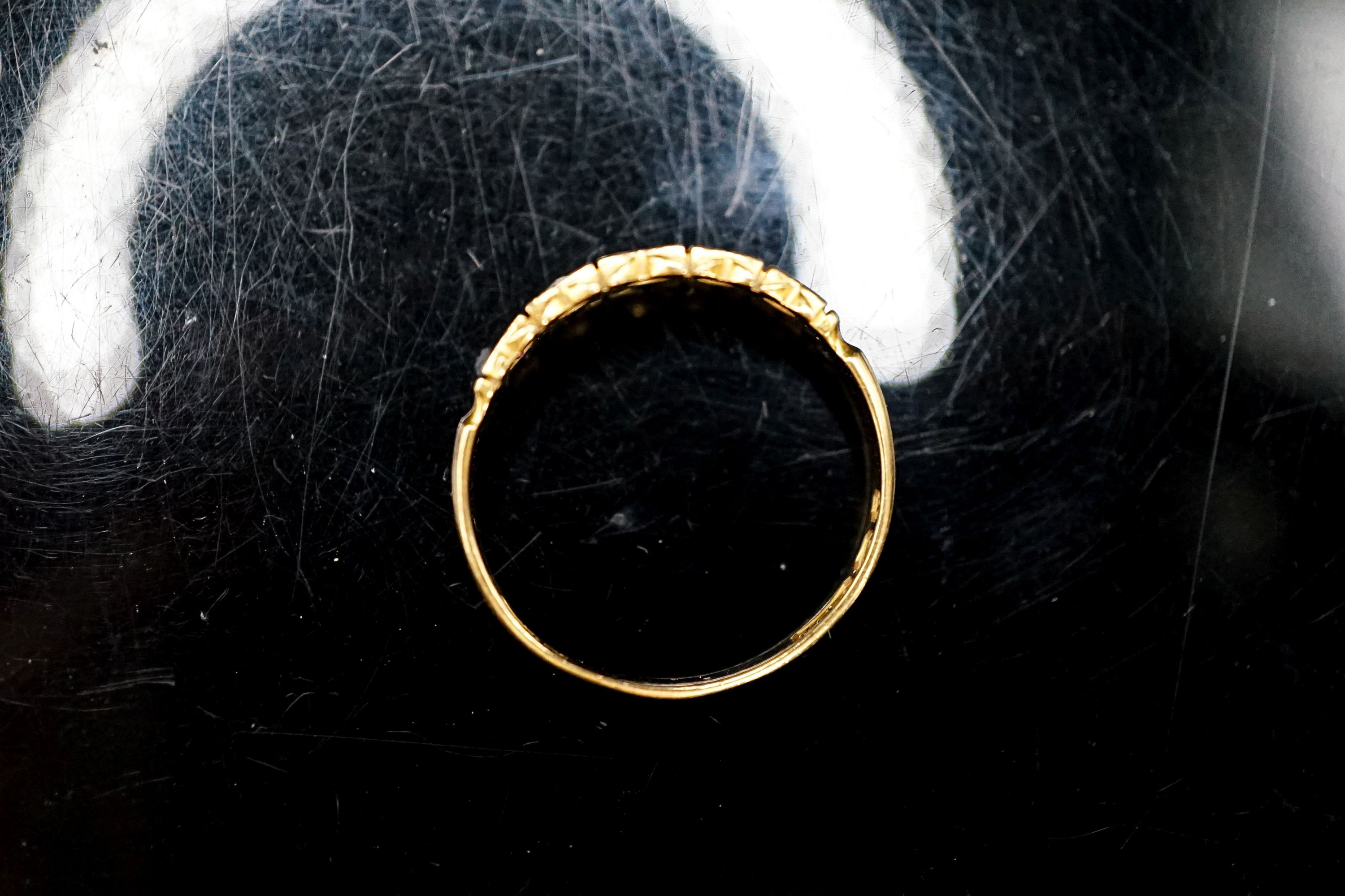 A late Victorian 18ct gold, ruby and diamond chip set half hoop ring, size O, gross 2.5 grams.